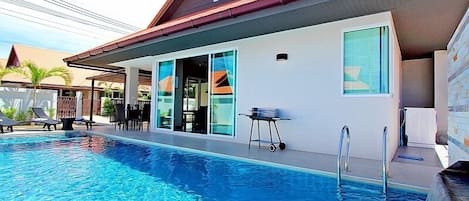 Living area leads to swimming pool with kid area.