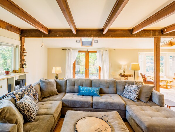 Welcoming living room- sectional couch, french doors to large deck
