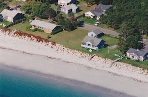 Aerial view - blue house in middle of photo.