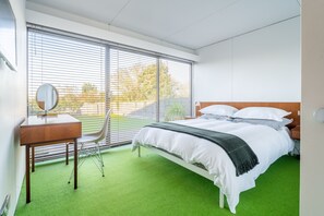 Bramley, Old Hunstanton: Master bedroom with king-size bed and sliding doors to garden