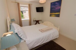 Ground floor:  Bedroom one with king-size bed and television