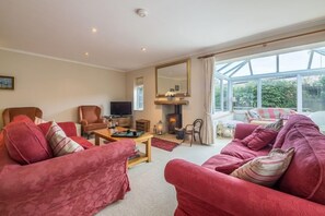 The Lifeboat House, Brancaster: Sitting room with wood burning stove