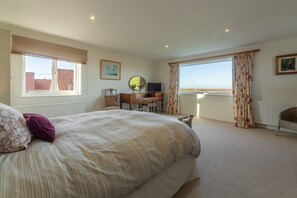 Sandpipers, Brancaster: Dual aspect master bedroom with saltmarsh views