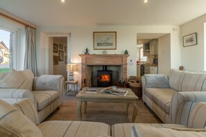 Sandpipers, Brancaster: Dual aspect sitting room with wood burning stove