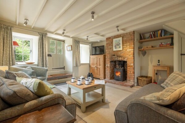 Sutton Cottage, Thornham: Cosy sitting room with wood burning stove