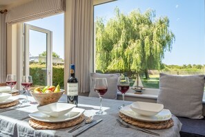 Tanholt, Holme-next-the-Sea: Dining area with garden views