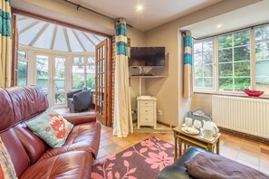 Ground floor: The sitting room leads to the conservatory