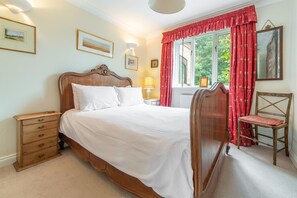 Saxon Shore Cottage, Burnham Deepdale: Bedroom one with an antique bed