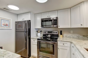 Upgraded Kitchen Featuring Granite Countertops and New Stainless Steel Appliances