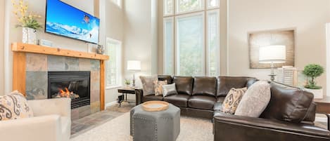 Family room with 30 foot ceilings and TV fireplace lounge area