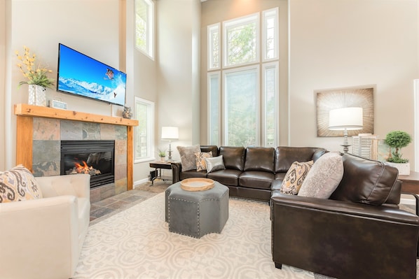 Family room with 30 foot ceilings and TV fireplace lounge area