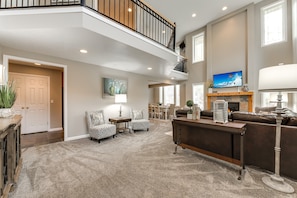 Gorgeous open concept great room with fireplace and balcony