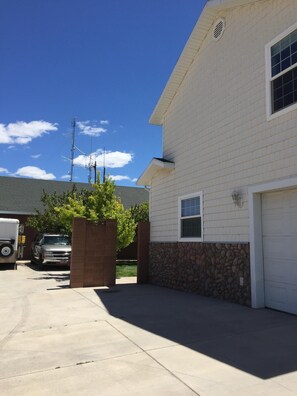 Left side of home, walk around to the back to enter the basement apartment