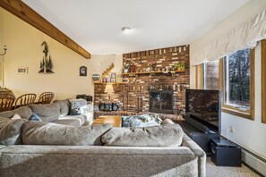 The living room has a wood burning fireplace.