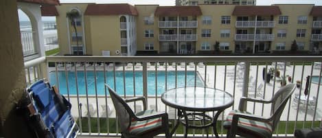 Balcony overlooks Olympic size pool, kiddie pool and courtyard, ocean to east.