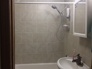 New shower with tiled floor and walls 
