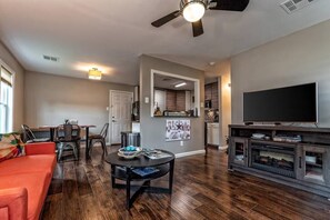 Open concept living/dining area.  Large screen TV with streaming, a fireplace and dining area large enough for 5.  The living room futon folds out to sleep 2.