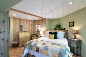 Bedroom with a door and desk provided for working space.