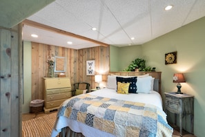 Bedroom with a door and desk provided for working space.