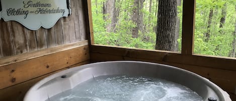 secluded hot tub with a forest view