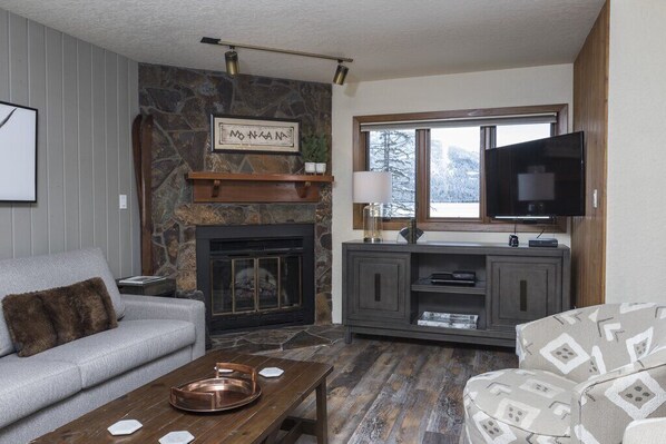 Updated living room with an electric fireplace.