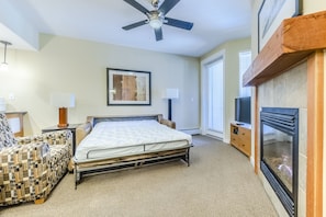 Living area - Brand new Queen sofa sleeper, gas fireplace, ceiling fan, and access to the private balcony.