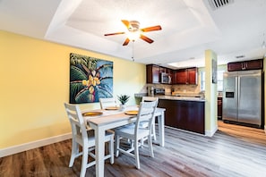 Dining room with new coastal table opening to kitchen and courtyard