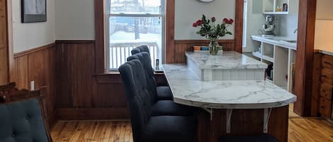 Large kitchen provides plenty of seating, natural light and adjoining pantry. 