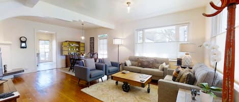  Comfortable living room area with an affluence of natural lighting.