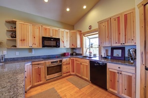 Kitchen with all modern appliances, dishwasher and granite countertops