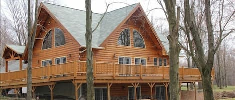 Huge wrap around 15'x75' deck overlooking bridge and 1 acre wooded lot