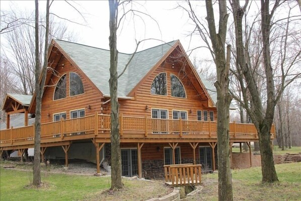 Huge wrap around 15'x75' deck overlooking bridge and 1 acre wooded lot