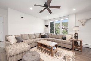 Plenty of seating in the living area with access to mountain views and a private balcony.