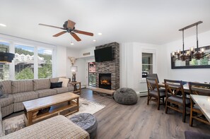 Open concept includes living area, dining area, kitchen, and access to the balcony.