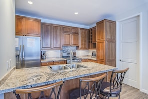 Kitchen - Granite counter tops, and counter-height stool seating.