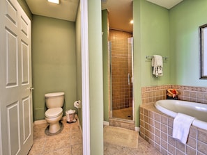 Large master bathroom has private lavatory, walk in shower and garden tub
