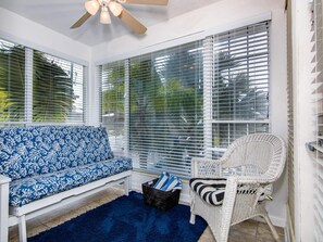 Walk into a bright sunroom with sleeper couch