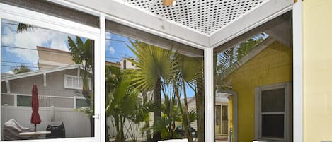 Screened in patio looks into the courtyard.