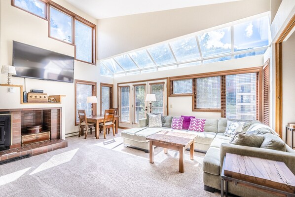 Living Area - Sky lights, flat screen TV, gas fireplace, and access to the private balcony.
