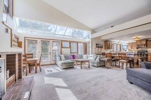 Living Area - Vaulted ceiling, gas fireplace, flat screen TV, and seating area perfect for family games or additional dining seating.