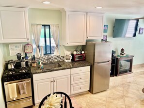 Full view of kitchen with all utensils, microwave, coffee pot, etc.