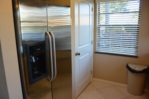 Large kitchen pantry, side by side Refrigerator with water/ice on door.