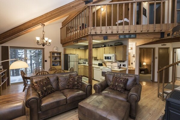 Open living space with loft above.