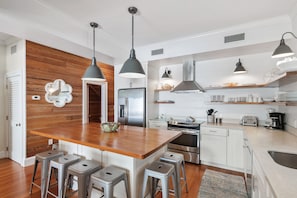 Beautiful kitchen with white granite counter tops and island