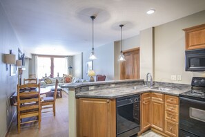 Kitchen - Granite counters, double sinks, full size appliances.