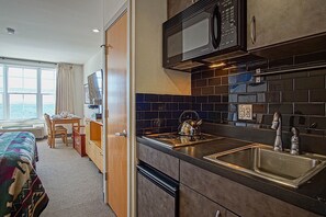 Kitchenette, counter top stove, mini refrigerator and microwave.