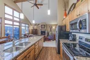 Kitchen - Granite counters, full size stainless steel appliances, and seating for five at the counter.