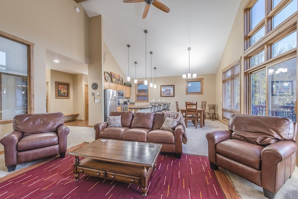 Living Area - Large area with vaulted ceiling, access to private balcony, fireplace, and flat screen TV.