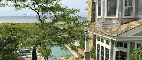 View to pool, main house, and Bay from Carriage house deck.