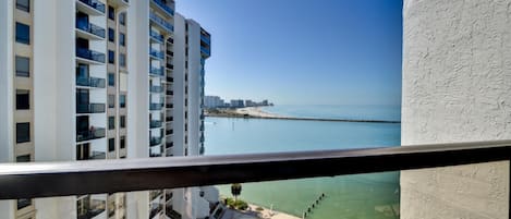 Balcony has view of the water and the pool.